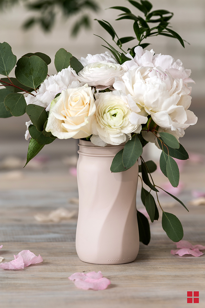 Roses in a pale pink flower vase.